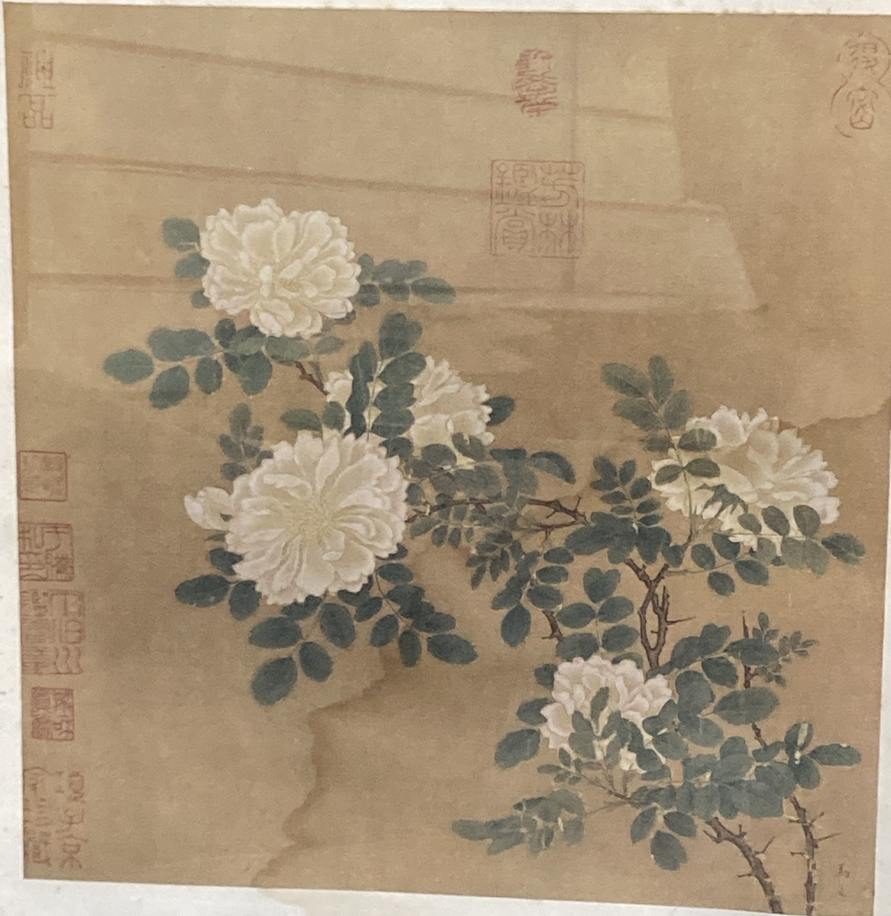 A Chinese painted fan leaf depicting a mountain scene, 43 x 21cm and a Chinese picture of peonies